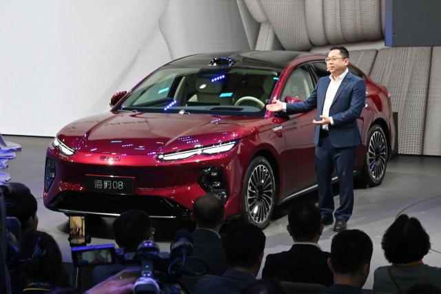 BYD CEO Wang Chuanfu speaks at the launch of the BYD Seal 08 on the opening day of the Beijing Auto Show in Beijing on April 24, 2026. (Photo by Danai Howard / AFP)
