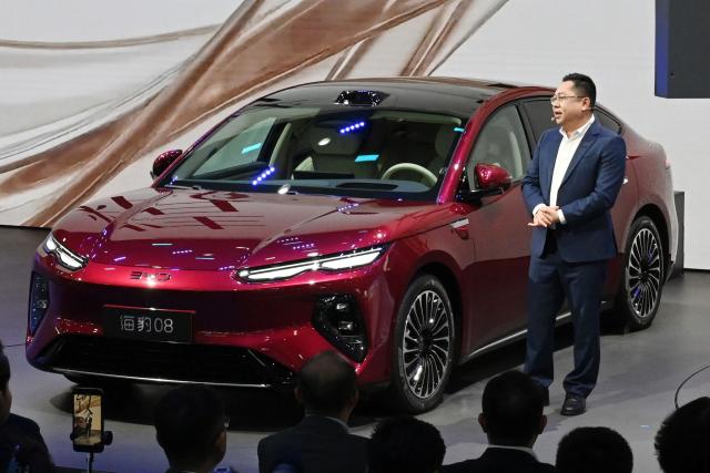 BYD CEO Wang Chuanfu speaks at the launch of the BYD Seal 08 on the opening day of the Beijing Auto Show in Beijing on April 24, 2026. (Photo by Danai Howard / AFP)