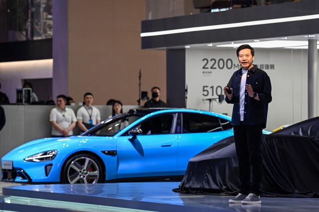 Lei Jun, Chairman and CEO of Chinese electronics company Xiaomi, introduces Xiaomi's Vision Gran Turismo concept car at the Beijing Auto Show in Beijing on April 24, 2026. (Photo by JADE GAO / AFP)