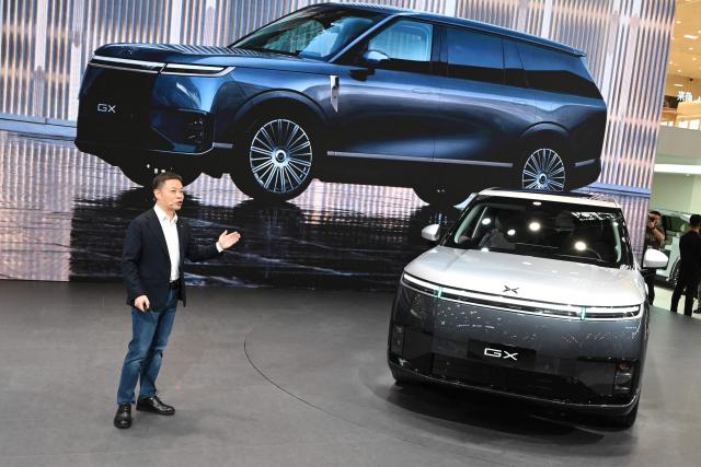XPeng CEO He Xiaopeng speaks at the launch of the Xpeng GX on the opening day of the Beijing Auto Show in Beijing on April 24, 2026. (Photo by Danai Howard / AFP)
