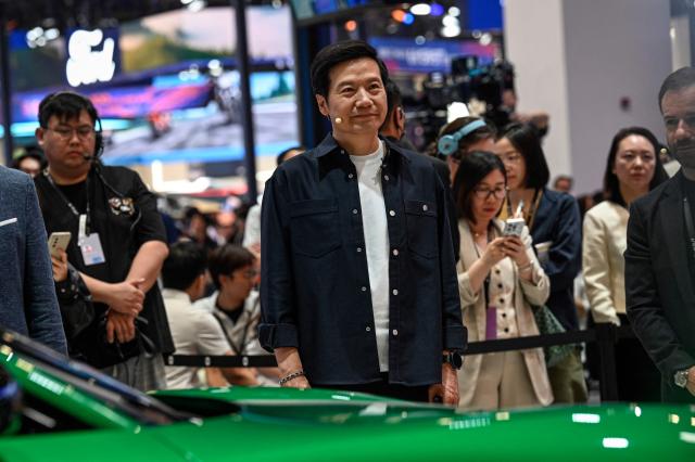 Lei Jun, Chairman and CEO of Chinese electronics company Xiaomi, stands next to the Xiaomi's electric car YU7 at the Beijing Auto Show in Beijing on April 24, 2026. (Photo by JADE GAO / AFP)