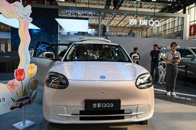 Chery's electric car QQ3 is displayed at the Beijing Auto Show in Beijing on April 24, 2026. (Photo by JADE GAO / AFP)