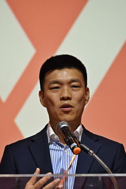 Natthaphong Ruengpanyawut, member of parliament and leader of Thailand’s opposition People’s Party, speaks during a press conference alongside fellow party MPs accused of proposing amendments to the lese-majeste law, in Bangkok on April 24, 2026. A Thai court on April 24 decided to hear a case against 10 MPs including the leader of the largest opposition party for trying to reform the royal insult law, but refrained from suspending them. (Photo by Lillian SUWANRUMPHA / AFP)