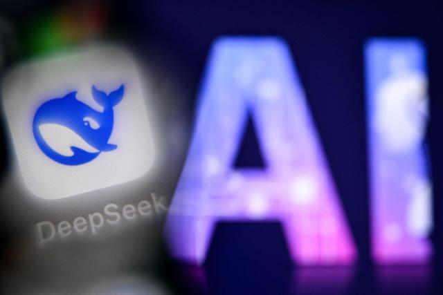 (FILES) This photo taken on September 1, 2025 shows the letters AI for Artificial Intelligence on a laptop screen (R) next to the the logo of the Deepseek AI application on a smartphone screen in Frankfurt am Main, western Germany. Chinese startup DeepSeek released a new artificial intelligence model with "drastically reduced" costs on April 24, 2026, more than a year after it stunned the world with a low-cost reasoning model that matched the capabilities of US rivals. (Photo by Kirill KUDRYAVTSEV / AFP)