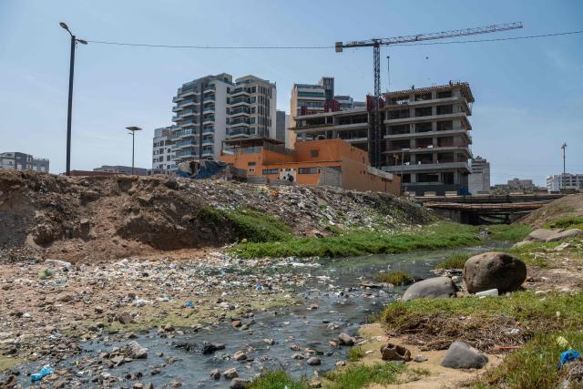 A general view of a sewage outfall at ‘Virage’ beach in Dakar, Senegal, on April 23, 2026. According to a report published today, ‘Virage’ beach is one of the sites identified where water quality is generally satisfactory but shows some contamination.   A campaign to improve the quality of recreational waters in Senegal was launched today by the Surfrider Foundation Senegal and dozens of organisations along the Dakar coastline committed to protecting the ocean. They are leading a ‘Water Quality’ programme aimed at ensuring that coastal users can enjoy water-based activities without health risks, whilst contributing to the sustainable preservation of Senegal’s coastline. (Photo by NICOLAS REMENE / AFP)
