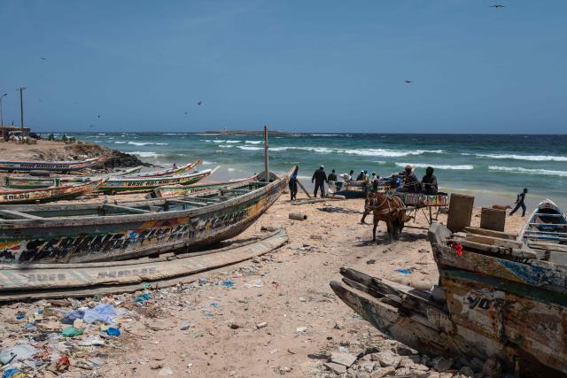 TOPSHOT - A view of the coastline at Yoff Beach in Dakar, Senegal, on April 23, 2026. Small-scale fishing is a major activity in this part of Dakar along this stretch of coastline.According to a report published today, Yoff Beach is one of the sites identified as ‘at risk’ and requiring significant efforts to maintain water sports activities. A campaign to improve the quality of recreational waters in Senegal was launched today by the Surfrider Foundation Senegal and dozens of organisations along the Dakar coastline committed to protecting the ocean. They are leading a ‘Water Quality’ programme aimed at ensuring that coastal users can enjoy water-based activities without health risks, whilst contributing to the sustainable preservation of Senegal’s coastline. (Photo by NICOLAS REMENE / AFP)