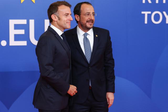 Cyprus' President Nikos Christodoulides (R) welcomes France's President Emmanuel Macron ahead of an informal meeting of the European Council in Nicosia on April 24, 2026. (Photo by Yves Herman / POOL / AFP)