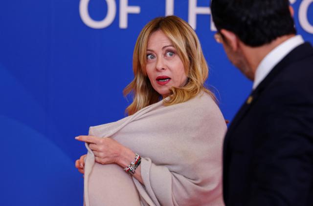 Cyprus' President Nikos Christodoulides (R) welcomes Italy's Prime Minister Giorgia Meloni ahead of an informal meeting of the European Council in Nicosia on April 24, 2026. (Photo by Yves Herman / POOL / AFP)