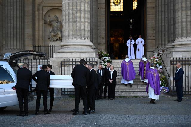 The coffin of French actress Nathalie Baye is carrying out of the hearse at the Saint-Sulpice church during her funeral ceremony in Paris on April 24, 2026. French film star Nathalie Baye died in Paris on April 17, 2026, at the age of 77. (Photo by JULIEN DE ROSA / AFP)