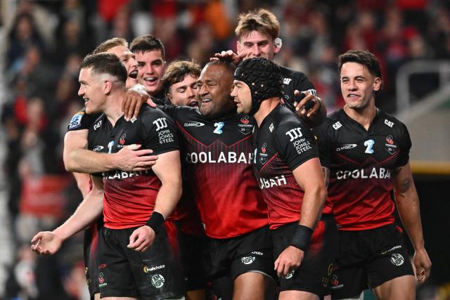 Crusaders' players celebrate during the Super Rugby Pacific match between the Canterbury Crusaders and NSW Waratahs at One New Zealand Stadium in Christchurch on April 24, 2026. (Photo by Sanka VIDANAGAMA / AFP)