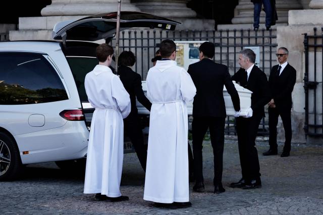 Pall-bearers load the coffin of French actress Nathalie Baye into the hearse after her funeral ceremony at the Saint-Sulpice church in Paris on April 24, 2026. French film star Nathalie Baye died on April 17, 2026, at the age of 77. (Photo by STEPHANE DE SAKUTIN / AFP)