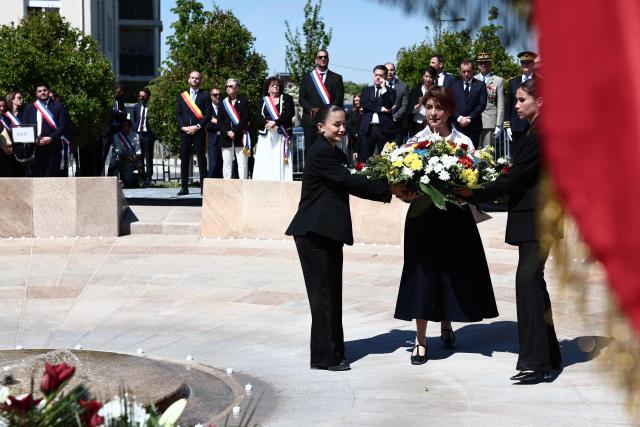 Aix-Marseille-Provence Metropole's president Martine Vassal carries a bunch of flowers as she attends a commemoration ceremony marking the 111th anniversary of the World War I-era mass killings of Armenians under the Ottoman Empire in 1915, at the "Memorial du Genocide" in Marseille, southeastern France, on April 24, 2026. (Photo by Thibaud MORITZ / AFP)