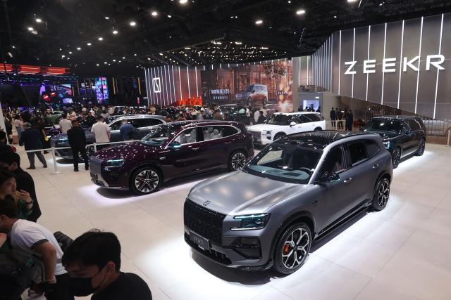 Visitors look at the Zeekr 8X (foreground) and other models on the opening day of the Beijing Auto Show in Beijing on April 24, 2026. (Photo by CN-STR / AFP) / China OUT