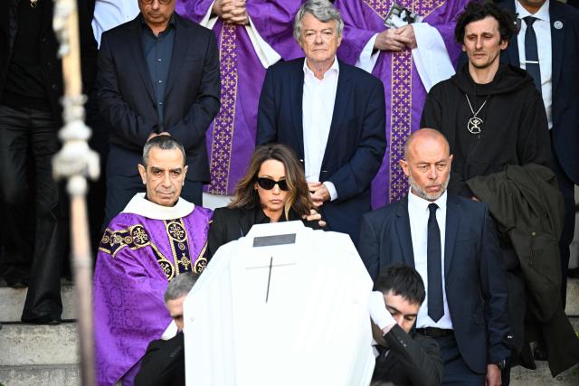 French actress Laura Smet and politician and former partner Jean-Louis Borloo follow the coffin after attending the funeral ceremony of her mother, French actress Nathalie Baye at the Saint-Sulpice church in Paris on April 24, 2026. French film star Nathalie Baye died on April 17, 2026, at the age of 77. (Photo by JULIEN DE ROSA / AFP)