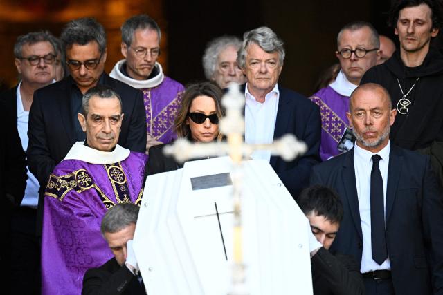 French actress Laura Smet and politician and former partner Jean-Louis Borloo follow the coffin after attending the funeral ceremony of her mother, French actress Nathalie Baye at the Saint-Sulpice church in Paris on April 24, 2026. French film star Nathalie Baye died on April 17, 2026, at the age of 77. (Photo by JULIEN DE ROSA / AFP)