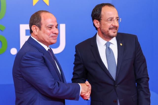 Cyprus' President Nikos Christodoulides (R) welcomes Egypt's President Abdel Fattah al-Sisi in Nicosia on April 24, 2026, on the sidelines of a European summit. European leaders vowed on April 24 to do more to de-escalate conflicts in the Middle East, as they prepared for discussions with regional counterparts from Egypt, Lebanon and Syria in Cyprus. (Photo by Yves Herman / POOL / AFP)