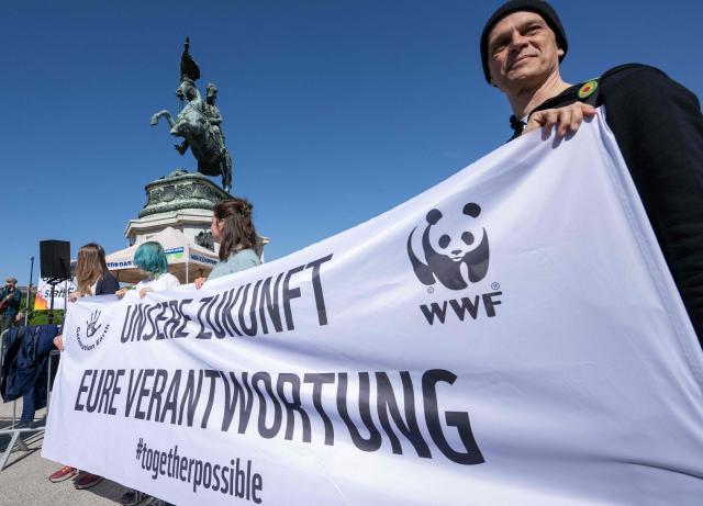 Participants hold a banner reading "Our Future, Your Responsibility" as they attend a demonstration organized by the Fridays For Future movement, "Our budget, our Future"  for an end of subsidies for oil and gas on April 24,2026, outside of the Hoffburg palace at the Helden square in Vienna, Austria. (Photo by Joe Klamar / AFP)