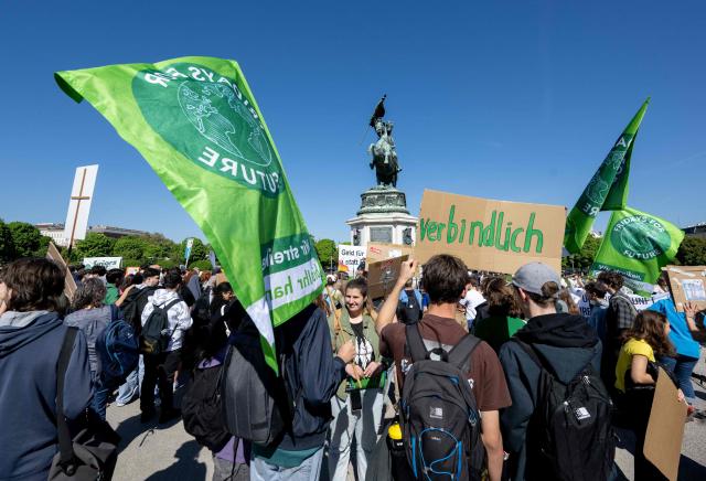 Students, teachers and environmental organizations attend a demonstration called by the Fridays For Future movement, "Our budget, our Future"  for an end of subsidies for oil and gas on April 24,2026, outside of the Hoffburg palace at the Helden square in Vienna, Austria. (Photo by Joe Klamar / AFP)