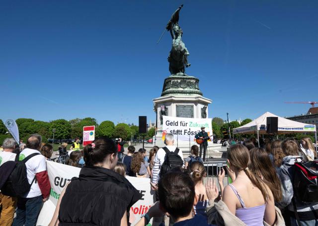 Activists perform on stage in front of students, teachers and environmental organizations during a demonstration called by the Fridays For Future movement, "Our budget, our Future"  for an end of subsidies for oil and gas on April 24,2026, outside of the Hoffburg palace at the Helden square in Vienna, Austria. (Photo by Joe Klamar / AFP)