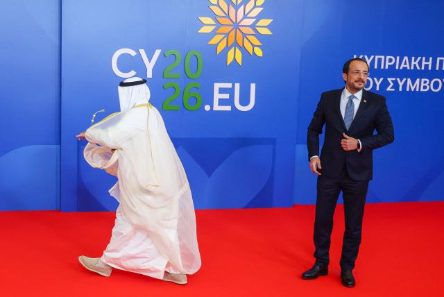Cyprus' President Nikos Christodoulides (R) welcomes Secretary General of the six-nation Gulf Cooperaetion Council (GCC), Jasem Mohamed al-Budaiwi, as he arrives for a working session of the European Council during an informal meeting in Nicosia on April 24, 2026. (Photo by Yves Herman / POOL / AFP)