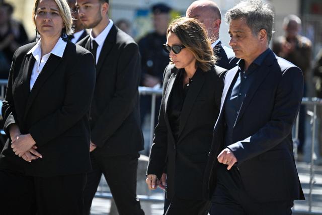 French actress Laura Smet talks with her husband and lawyer Raphael Lancrey-Javal after attending the funeral ceremony of her mother, French actress Nathalie Baye at the Saint-Sulpice church in Paris on April 24, 2026. French film star Nathalie Baye died on April 17, 2026, at the age of 77. (Photo by JULIEN DE ROSA / AFP)