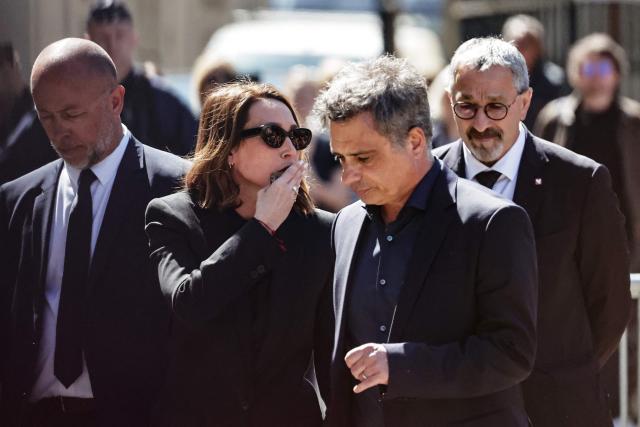 French actress Laura Smet talks with her husband and lawyer Raphael Lancrey-Javal after attending the funeral ceremony of her mother, French actress Nathalie Baye at the Saint-Sulpice church in Paris on April 24, 2026. French film star Nathalie Baye died on April 17, 2026, at the age of 77. (Photo by STEPHANE DE SAKUTIN / AFP)