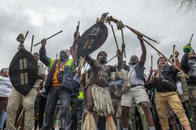 Protesters sing and chant during a protest march against undocumented migrants in the town of Estcourt on April 24, 2026. South Africa's acting police minister has condemned xenophobic incidents, saying attacks on foreign nationals were "unlawful" and violated the country's constitutional values of dignity and equality. (Photo by RAJESH JANTILAL / AFP)