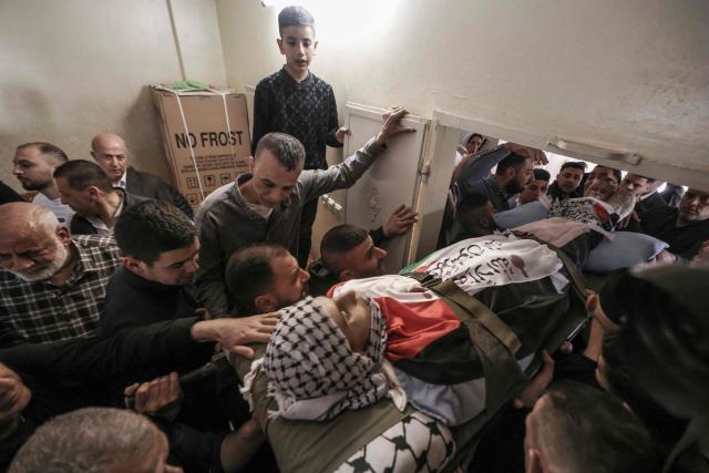 EDITORS NOTE: Graphic content / Mourners carry the body of 15-year-old Youssef Sameh Shtayyeh during his funeral in the village of Till, west of Nablus, in the Israeli-occupied West Bank, on April 24, 2026. Israeli troops killed a teenage boy during a raid in the occupied West Bank city of Nablus on April 23, the Palestinian health ministry said, with the Israeli military saying forces fired at a stone thrower. (Photo by JAAFAR ASHTIYEH / AFP)