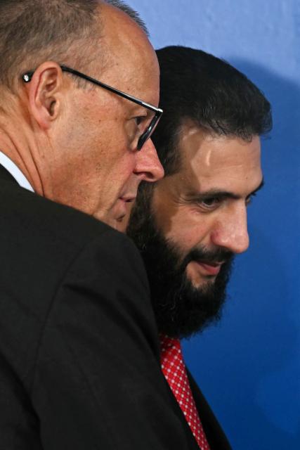 Syria's President Ahmed al-Sharaa (R) chats with Germany's Chancellor Friedrich Merz after a working session of the European Council and regional partners as part of an informal meeting in Nicosia on April 24, 2026. (Photo by NICOLAS TUCAT / AFP)