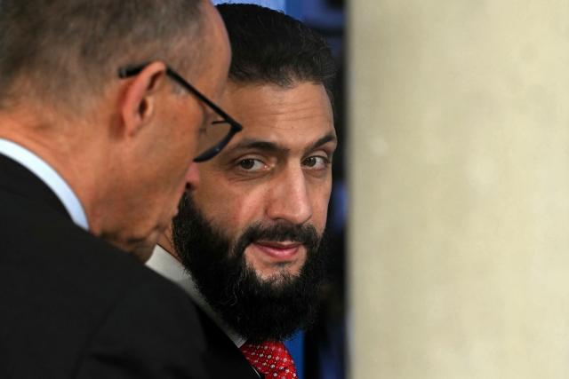 Syria's President Ahmed al-Sharaa (R) chats with Germany's Chancellor Friedrich Merz after a working session of the European Council and regional partners as part of an informal meeting in Nicosia on April 24, 2026. (Photo by NICOLAS TUCAT / AFP)