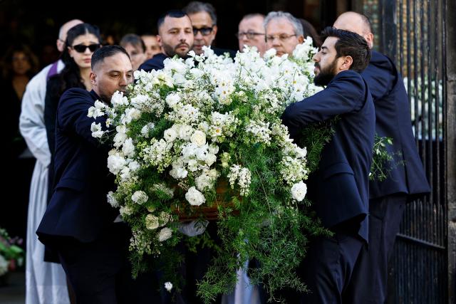 Pallbearers carry the coffin of French actress Nadia Fares after the funeral ceremony at the Saint-Jean de Montmartre church in Paris on April 24, 2026. Nadia Fares died on April 17, 2026, aged 57, after being found unconscious in a swimming pool in Paris and several days in a coma. (Photo by SIMON WOHLFAHRT / AFP)