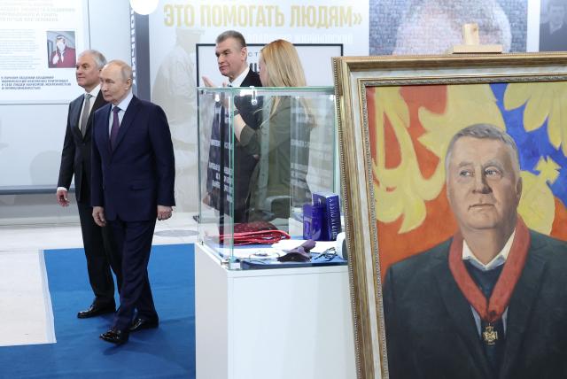 In this pool photograph distributed by the Russian state agency Sputnik, Russia's President Vladimir Putin, accompanied by Russian State Duma Speaker Vyacheslav Volodin and Leonid Slutsky, the head of Russia's hardline Liberal Democrat party, visits an exhibition dedicated to the late leader of the Liberal Democratic Party of Russia (LDPR) Vladimir Zhirinovsky in Moscow on April 24, 2026. (Photo by Valery SHARIFULIN / POOL / AFP)