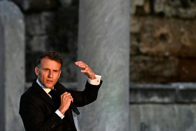 France's President Emmanuel Macron speaks on stage during an event at the Roman Agora in Athens, on April 24, 2026. Emmanuel Macron is in a two-days visit to Greece to strengthen Franco-Greek cooperation on defence and security. (Photo by Aris MESSINIS / AFP)