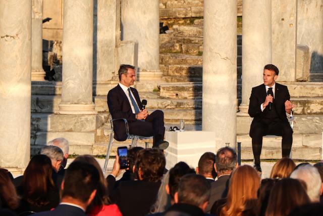 France's President Emmanuel Macron (R) and  Greece's Prime Minister Kyriakos Mitsotakis (L) speak on stage during an event at the Roman Agora in Athens, on April 24, 2026. Emmanuel Macron is in a two-days visit to Greece to strengthen Franco-Greek cooperation on defence and security. (Photo by Ludovic MARIN / AFP)