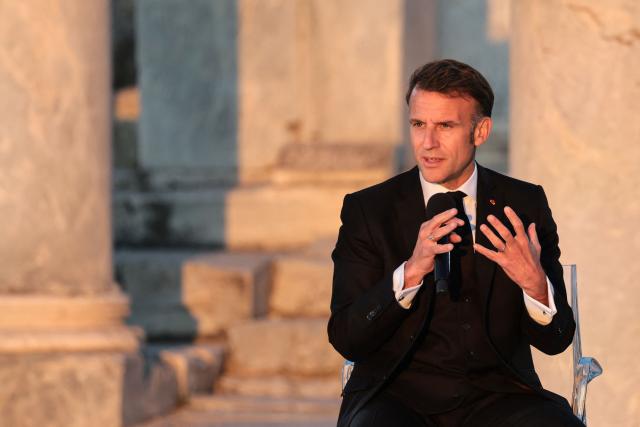 France's President Emmanuel Macron speaks on stage during an event at the Roman Agora in Athens, on April 24, 2026. Emmanuel Macron is in a two-days visit to Greece to strengthen Franco-Greek cooperation on defence and security. (Photo by Ludovic MARIN / AFP)