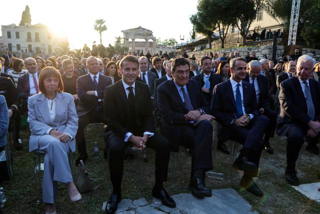 France's President Emmanuel Macron (2nd L), Kathimerini Executive Editor Alexis Papachelas (C) and Greece's Prime Minister Kyriakos Mitsotakis (2nd R) attend an event at the Roman Agora in Athens, on April 24, 2026. Emmanuel Macron is in a two-days visit to Greece to strengthen Franco-Greek cooperation on defence and security. (Photo by Ludovic MARIN / AFP)