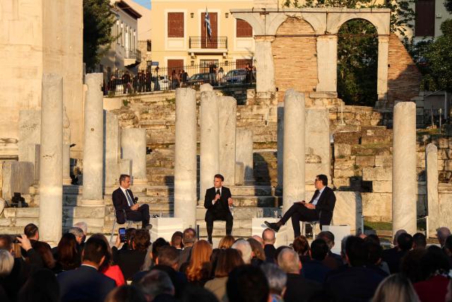 Greece's Prime Minister Kyriakos Mitsotakis, France's President Emmanuel Macron, and Kathimerini Executive Editor Alexis Papachelas  speak on stage during an event at the Roman Agora in Athens, on April 24, 2026. Alexis Papachelas. Emmanuel Macron visits Athens to strengthen Franco-Greek cooperation on defence and security. (Photo by Ludovic MARIN / AFP)