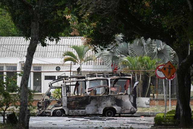 A view of a bus bomb after an explosion near a military base in Cali, Valle del Cauca department, Colombia taken on April 24, 2026. One person was injured in an attack on a military base in southwest Colombia on April 24, 2026, according to the local health authority, one month ahead of the presidential election. (Photo by JOAQUIN SARMIENTO / AFP)
