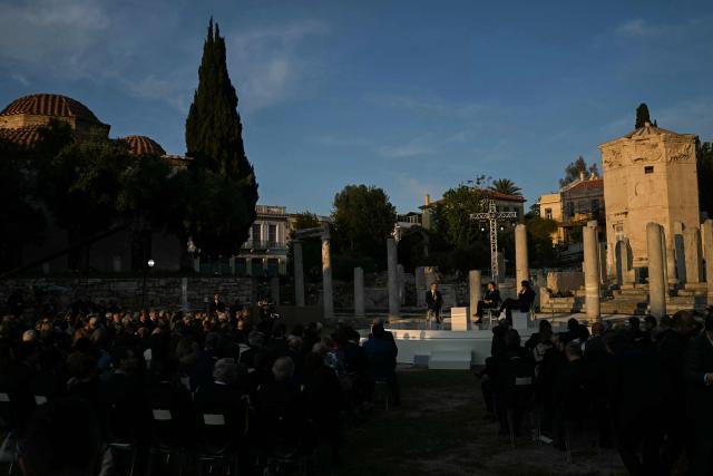 Greece's Prime Minister Kyriakos Mitsotakis, France's President Emmanuel Macron, and Kathimerini Executive Editor Alexis Papachelas  speak on stage during an event at the Roman Agora in Athens, on April 24, 2026. Alexis Papachelas. Emmanuel Macron visits Athens to strengthen Franco-Greek cooperation on defence and security. (Photo by Aris MESSINIS / AFP)
