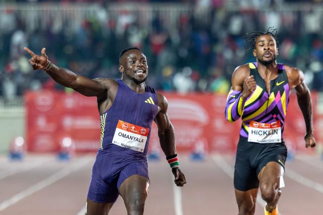 TOPSHOT - Kenya’s Ferdinand Omanyala (L) celebrates as he crosses the finish line to win the 100m men's event during the sixth edition of the Kip Keino Classic Continental Tour Gold at the Nyayo National Stadium in Nairobi, on April 24, 2026. (Photo by Luis TATO / AFP)