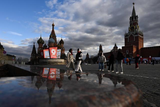Tourists visit Red Square adorned with first Victory Day decorations in central Moscow on April 24, 2026. Russia will celebrate the 81st anniversary of the 1945 victory over Nazi Germany on May 9. (Photo by Igor IVANKO / AFP)