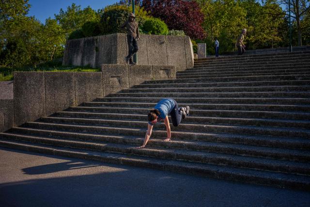 A woman exercises on stairs along the Seine River promenade in Paris on April 24, 2026. (Photo by Dimitar DILKOFF / AFP)