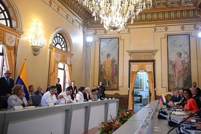 Venezuela's interim President, Delcy Rodriguez (R), and Colombia's President Gustavo Petro, hold a bilateral meeting at the Miraflores Presidential Palace in Caracas on April 24, 2026. Colombia's President Gustavo Petro arrived in Venezuela on April 24 for a bilateral meeting with interim President Delcy Rodriguez, focusing on border security and energy cooperation. (Photo by Federico PARRA / AFP)