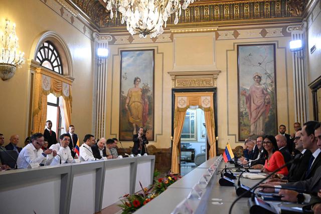 Venezuela's interim President, Delcy Rodriguez (R), and Colombia's President Gustavo Petro, hold a bilateral meeting at the Miraflores Presidential Palace in Caracas on April 24, 2026. Colombia's President Gustavo Petro arrived in Venezuela on April 24 for a bilateral meeting with interim President Delcy Rodriguez, focusing on border security and energy cooperation. (Photo by Federico PARRA / AFP)