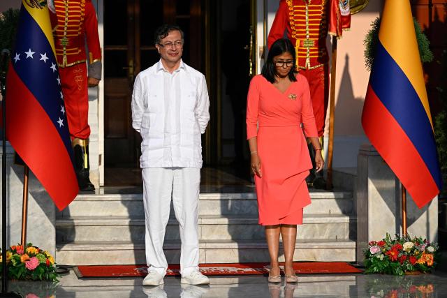 Venezuela's interim President Delcy Rodriguez (R) and Colombian President Gustavo Petro arrive to deliver statements after a bilateral meeting at the Miraflores presidential palace in Caracas on April 24, 2026. Colombia's President Gustavo Petro arrived in Venezuela on April 24 for a bilateral meeting with interim President Delcy Rodriguez, focusing on border security and energy cooperation. (Photo by Federico PARRA / AFP)