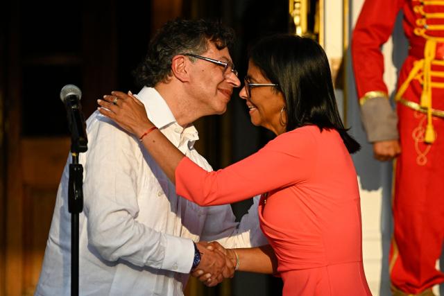 Venezuela's interim President Delcy Rodriguez (R) and Colombian President Gustavo Petro shake hands after delivering statements following a bilateral meeting at the Miraflores presidential palace in Caracas on April 24, 2026. Colombia's President Gustavo Petro arrived in Venezuela on April 24 for a bilateral meeting with interim President Delcy Rodriguez, focusing on border security and energy cooperation. (Photo by Federico PARRA / AFP)
