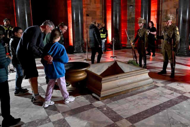 People lay poppies in the Shrine after the Anzac Day dawn service at the Shrine of Remembrance to remember soldiers who have died in war, in Melbourne on April 25, 2026. (Photo by William WEST / AFP)