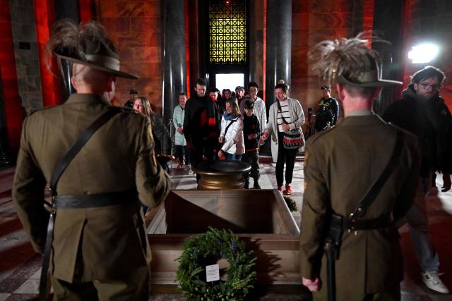 People lay poppies in the Shrine after the Anzac Day dawn service at the Shrine of Remembrance to remember soldiers who have died in war, in Melbourne on April 25, 2026. (Photo by William WEST / AFP)