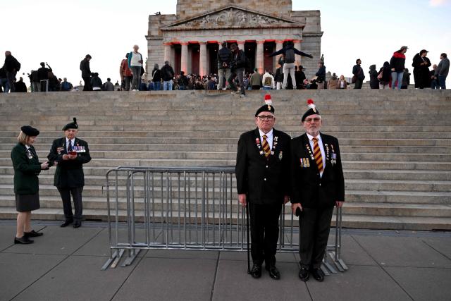 Veterans pose for a photo after the Anzac Day dawn service at the Shrine of Remembrance to remember soldiers who have died in war, in Melbourne on April 25, 2026. (Photo by William WEST / AFP)
