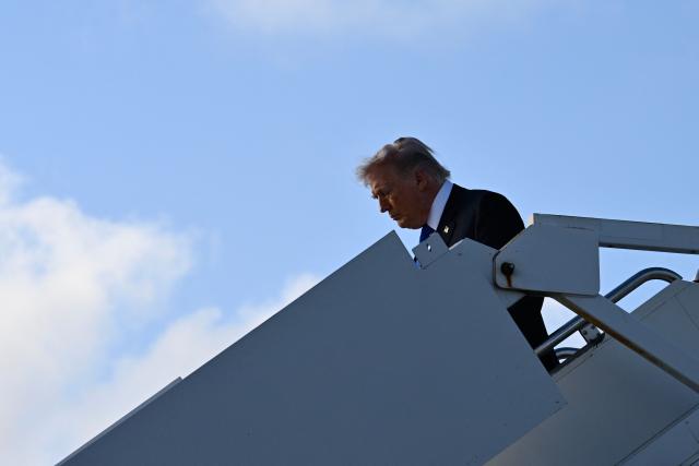 US President Donald Trump steps off Air Force One at Palm Beach International Airport in West Palm Beach, Florida on April 24, 2026. President Trump is heading to Palm Beach to attend the Republican National Committee (RNC) spring retreat. (Photo by Kent NISHIMURA / AFP)